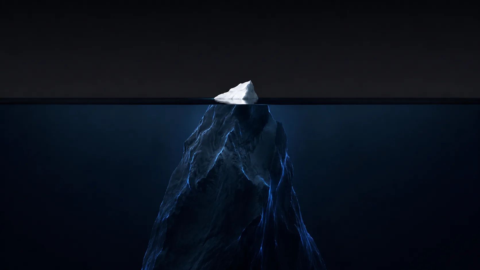 An iceberg: a small white tip above the waterline, a vast dark mass beneath it